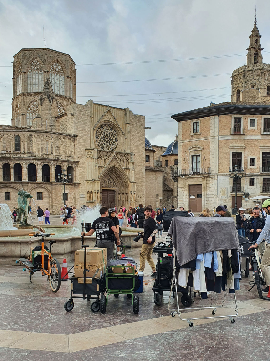 Photograph of the production team working on the Shimano project in the Plaza de la Virgen in Valencia, Spain. With the cathedral in the background.